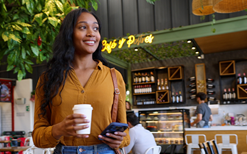woman smiling at credit card