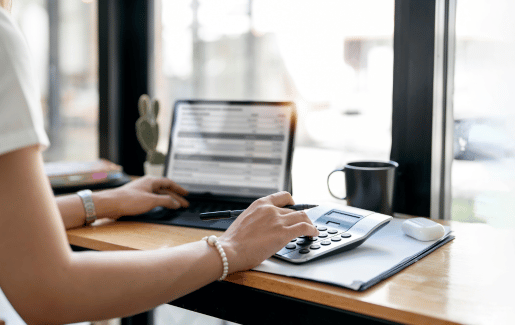 human on computer looking at finances